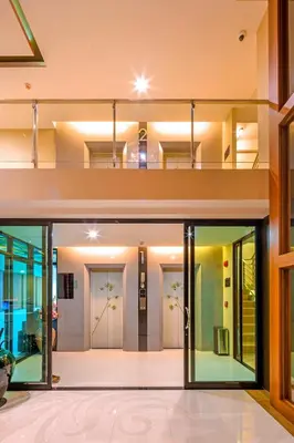 a house with glass doors and a balcony at At the tree by fatimah Rawai 408 in Rawai Beach