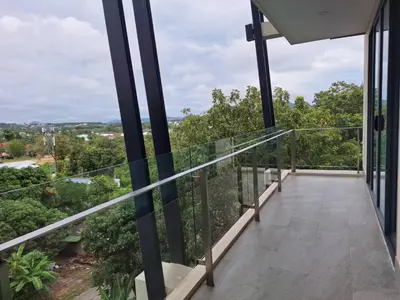 a balcony with a view of the forest at At the tree by fatimah Rawai 408 in Rawai Beach