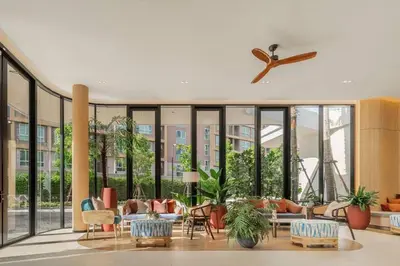 a lobby with a lot of furniture and windows at Dcondo reef 99 in Kathu