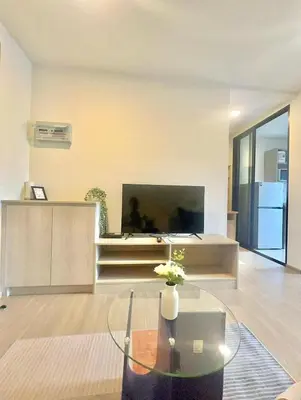 a living room with a tv and a glass table at Dcondo reef 99 in Kathu
