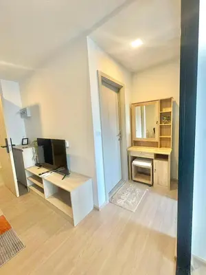 a room with a desk with a computer and a tv at Dcondo reef 99 in Kathu