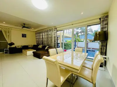 a living room with a dining table and a couch at Villa 3bd & pool - Rawai - Nai Harn in Rawai Beach