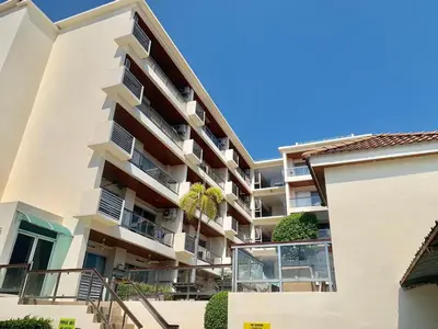 an apartment building with balconies and plants at Rawai Condominium By Wijitra in Phuket Town