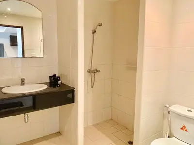 a bathroom with a shower and a sink and a toilet at Rawai Condominium By Wijitra in Phuket Town