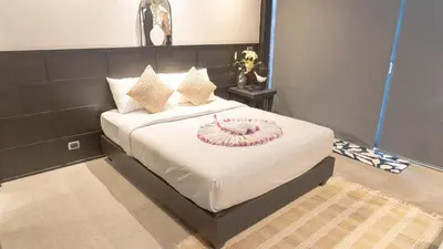 a bedroom with a bed with a plate on it at Jaokhun Hilltop Kamala, Phuket in Kamala Beach