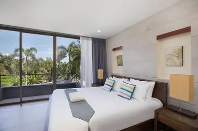 a bedroom with a large white bed and a balcony at Blissful Living & Tropical Vibes - 3BR Pool Access Villa Argent 9, just 15 min drive from Nai Yang and Nai Thon Beaches in Thalang