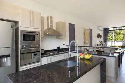 a kitchen with a sink and a counter top at Blissful Living & Tropical Vibes - 3BR Pool Access Villa Argent 9, just 15 min drive from Nai Yang and Nai Thon Beaches in Thalang