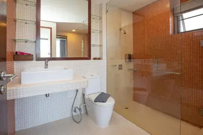 a bathroom with a toilet and a sink and a shower at Blissful Living & Tropical Vibes - 3BR Pool Access Villa Argent 9, just 15 min drive from Nai Yang and Nai Thon Beaches in Thalang