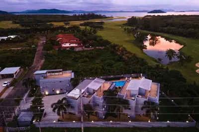an aerial view of a house with a lake at Blissful Living & Tropical Vibes - 3BR Pool Access Villa Argent 9, just 15 min drive from Nai Yang and Nai Thon Beaches in Thalang