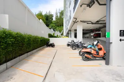 a row of scooters parked in a parking lot at Fantasea Condo Kamala B204 2BDRM by Phuket Sabay Rent in Kamala Beach
