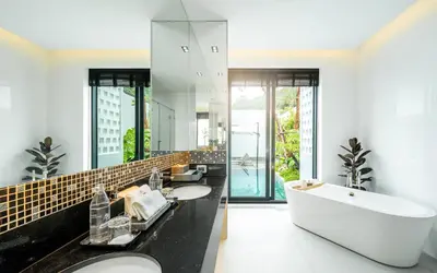 a bathroom with two sinks and a large mirror at MANDLA VILLAS COLLECTION, White Anda Naiharn in Rawai Beach