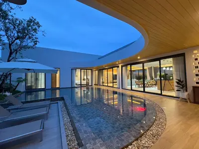an empty house with a swimming pool in the middle at MANDLA VILLAS COLLECTION, White Anda Naiharn in Rawai Beach