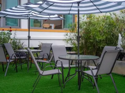 a group of tables and chairs with umbrellas at Elegant 4BR Villa with Pool2 in Ban Bang La