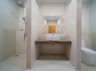 a white bathroom with a sink and a toilet at Elegant 4BR Villa with Pool2 in Ban Bang La