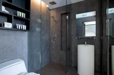 a bathroom with a glass shower and a toilet at Enjoy Tropical Bliss in Kamala Pool View Suite CTG P204, Top Facilities, near FantaSea & Café Del Mar Beach Club in Kamala Beach