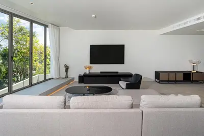 a living room with a couch and a flat screen tv at Sea Views 2BR ,,Adult Only,, Apartment 817 in Sapphire Bay Residence, Patong in Patong Beach