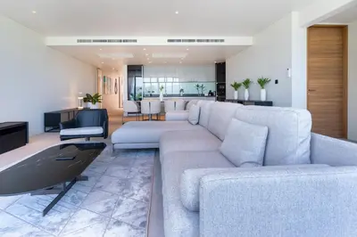 a living room with a white couch and a kitchen at Sea Views 2BR ,,Adult Only,, Apartment 817 in Sapphire Bay Residence, Patong in Patong Beach