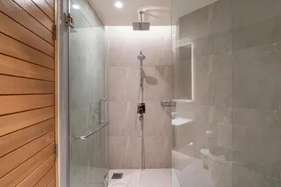 a bathroom with a shower with a glass door at Sea Views 2BR ,,Adult Only,, Apartment 817 in Sapphire Bay Residence, Patong in Patong Beach