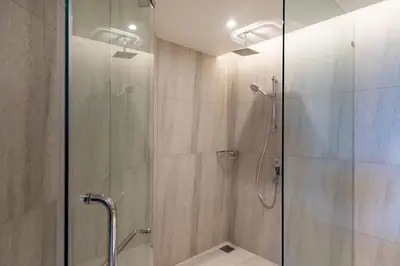 a bathroom with a shower with a glass door at Sea Views 2BR ,,Adult Only,, Apartment 817 in Sapphire Bay Residence, Patong in Patong Beach