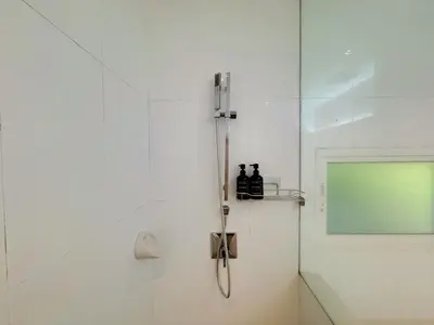 a shower with a glass door in a bathroom at Peaceful The Trees Kamala Hillside in Kamala Beach