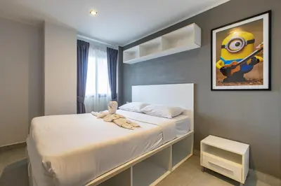 a small bedroom with a bed with white sheets at Modern Condo - 1BR T1 -501 in Chalong