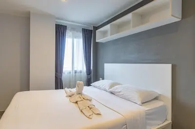 a bedroom with a bed with a towel on it at Modern Condo - 1BR T1 -501 in Chalong