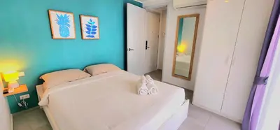 a bedroom with a bed with a pair of shoes on it at Cozy Apartment-1BR T2-524 in Chalong