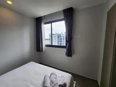 a bedroom with a bed with a pair of shoes on it at Cozy Apt-1BR T3-635 in Chalong