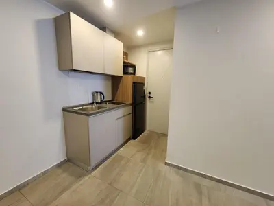 a small kitchen with a sink and a refrigerator at Cozy Apt-1BR T3-635 in Chalong