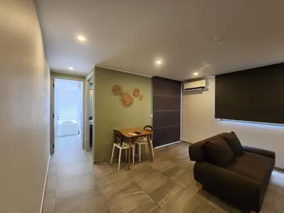 a living room with a couch and a table at Cozy Apt-1BR T3-635 in Chalong