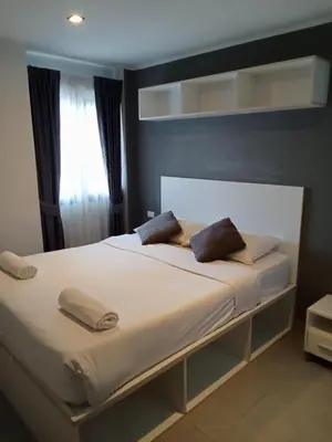 a bed with two pillows on it in a bedroom at Well located condo-1BR T1-NV-203 in Chalong