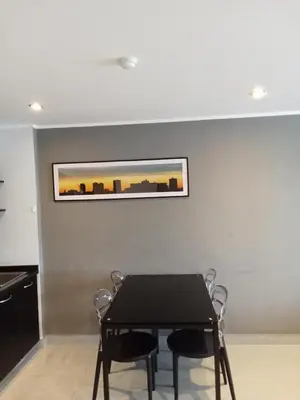 a dining room with a black table and chairs at Well located condo-1BR T1-NV-203 in Chalong