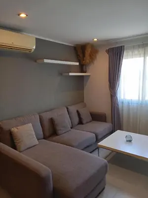 a living room with a couch and a table at Well located condo-1BR T1-NV-203 in Chalong