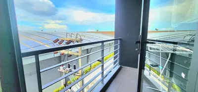 a balcony with a view of a building at Modern Condo - 1BR T1-401 in Chalong