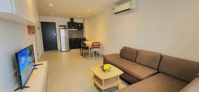 a living room with a couch and a table at Modern Condo - 1BR T1-401 in Chalong