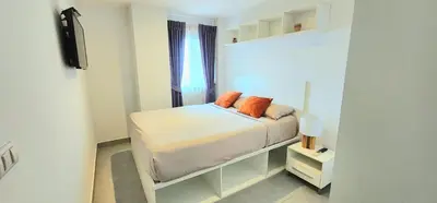 a small bedroom with a bed and a window at Modern Condo - 1BR T1-401 in Chalong