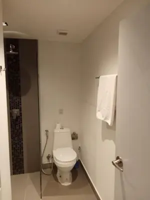 a white bathroom with a toilet and a shower at Modern Condo - 1BR T1-401 in Chalong