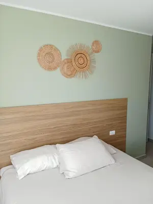 a bedroom with a white bed with two hats on the wall at Modern Condo - 1BR T3-528 in Chalong