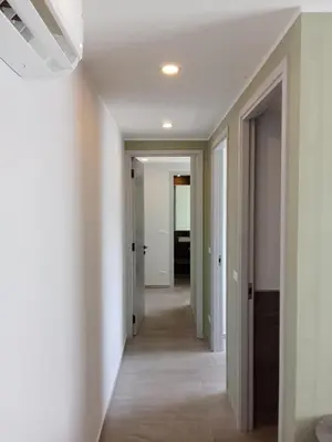 a hallway in a house with white walls and a ceiling at Modern Condo - 1BR T3-528 in Chalong
