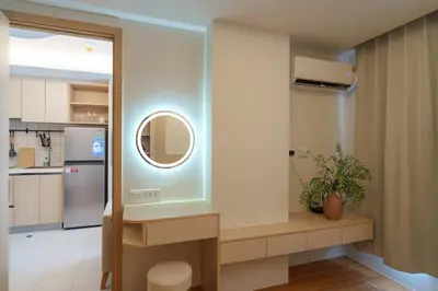 a kitchen with a sink and a mirror in a room at Cozy 1BdR Kamala Beach Pools on the Roof in Kamala Beach
