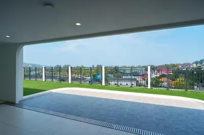 a large window in a house with a balcony at Cozy 1BdR Kamala Beach Pools on the Roof in Kamala Beach