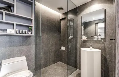 a bathroom with a glass shower and a toilet at Citygate resort in Kamala Beach