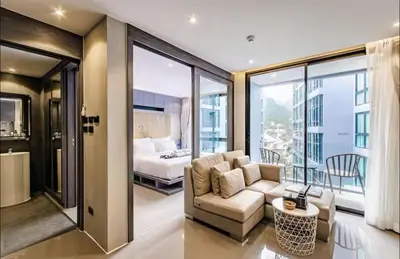 a living room with a couch and a bed at Citygate resort in Kamala Beach