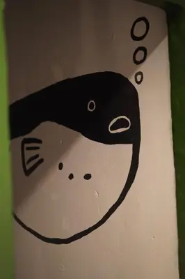 a drawing of a whale on a wall at Comfort Hostel Phuket Old Town by MaTong in Phuket Town