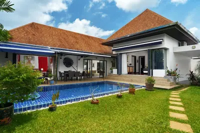 a house with a swimming pool in a yard at Henia Villa by G Estate Phuket in Ban Saiyuan (1)