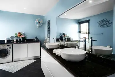 a bathroom with three sinks and a washing machine at Henia Villa by G Estate Phuket in Ban Saiyuan (1)
