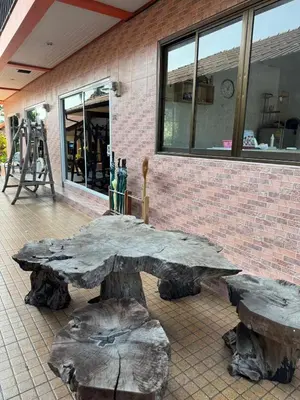 a stone table and benches in front of a building at Jampathong mansion in Ban Bo Han