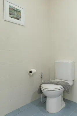 a bathroom with a toilet with a picture on the wall at At Sea condo Building C, Klong Muang Beach in Ban Ko Kwang