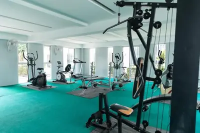 a gym with several treadmills and exercise bikes at At Sea condo Building C, Klong Muang Beach in Ban Ko Kwang