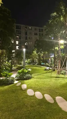 a park withestones in the grass in front of a building at Dcondo Reef Serenity Condo 2 in Phuket Town